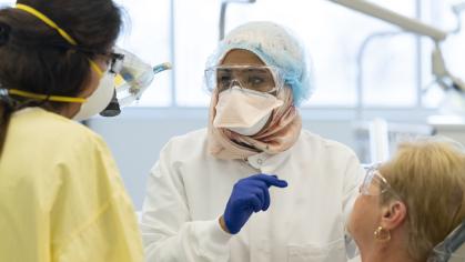 two dentists in clinic with a patient