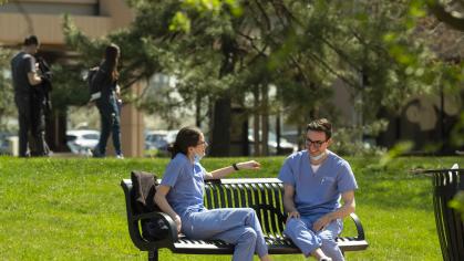 students sitting on bench outdoors