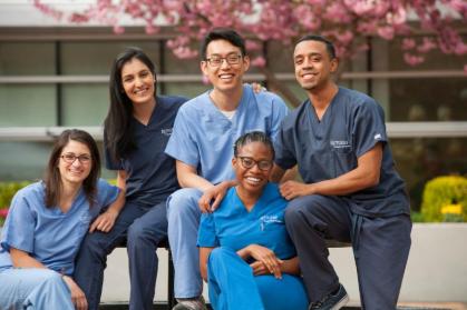 dental students posing together in courtyard