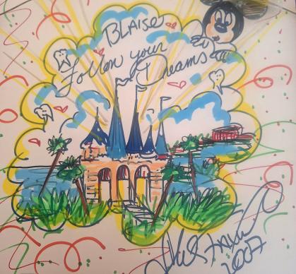 Colorful hand-drawn illustration featuring a castle with tall blue spires surrounded by greenery and palm trees, set against a bright sky with yellow rays and fluffy clouds. The artwork includes playful doodles of hearts, stars, and a cartoon character resembling Mickey Mouse in the upper right corner. Text in the center reads “Blaise Follow your Dreams,” and the bottom is signed with a name and the year 2007. The background is decorated with swirling lines and confetti-like patterns in red, green, and yell